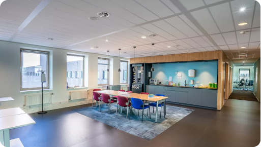 Modern office space with colorful chairs and meeting area